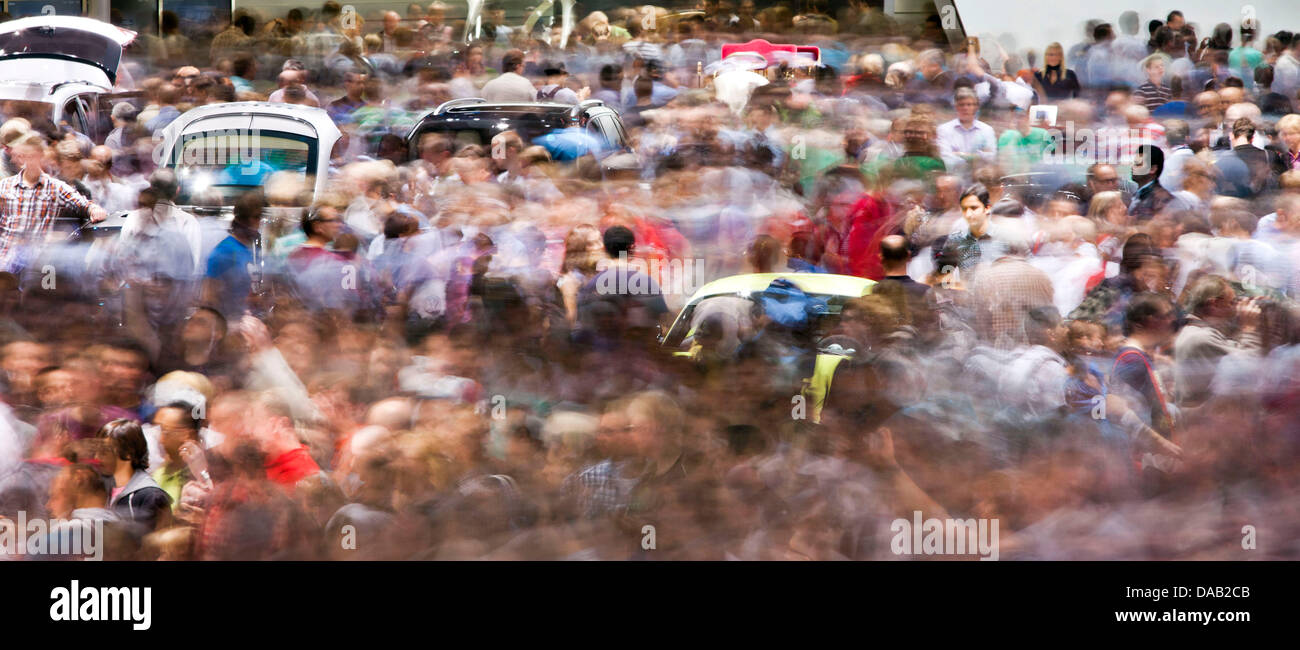 The cars can barely be seen because of the crowd of visitors at the ...