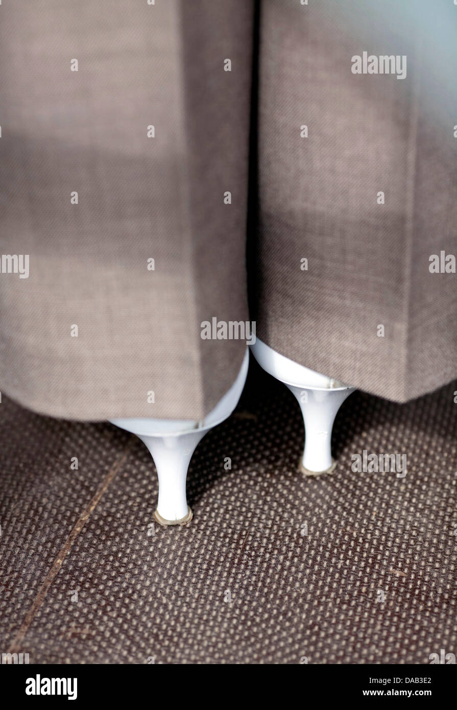 Thin white heels appear underneath the trouser legs of a business woman in Frankfurt Main, Germany, 6 September 2011. Photo: Frank Rumpenhorst Stock Photo