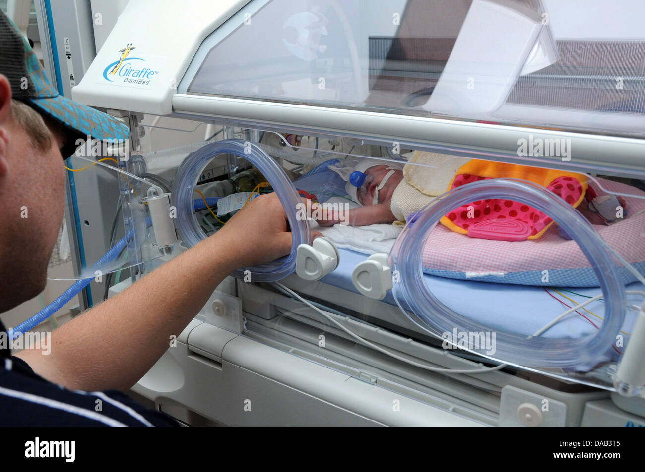 HANDOUT - A handout picture by the University of Greifswald dated 24 September 2011 shows a premature baby in a incubator in Greifswald, Germany. The small Paulina Emily was born on 8 June 2011 in the 22nd week of pregnancy and weighs only 290 grams, seized 27 centimeters. The baby survived although the 24th week of pregnancy is considered as the earliest possible week of birth. Ph Stock Photo