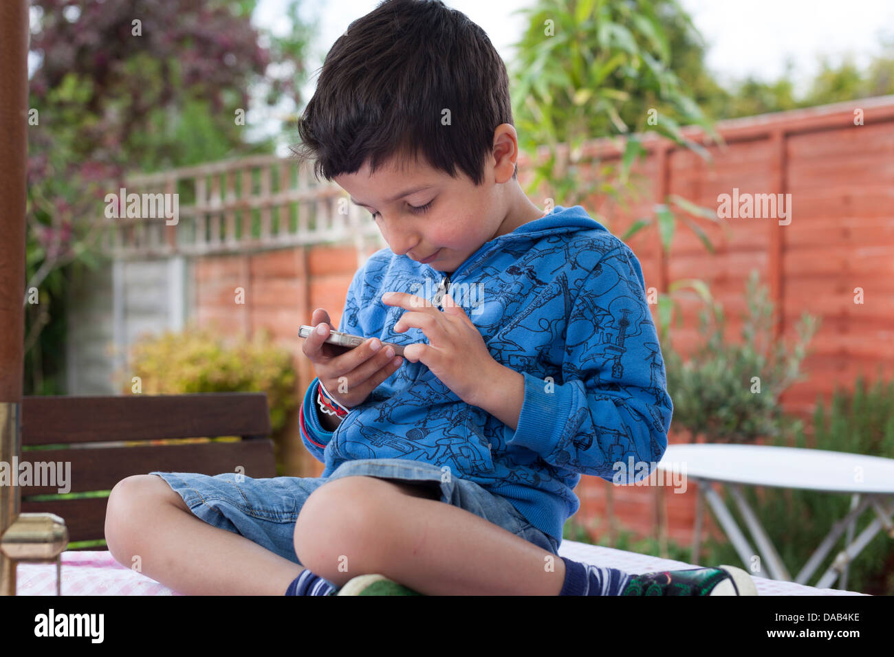 Child plays on a touch screen mobile device Stock Photo