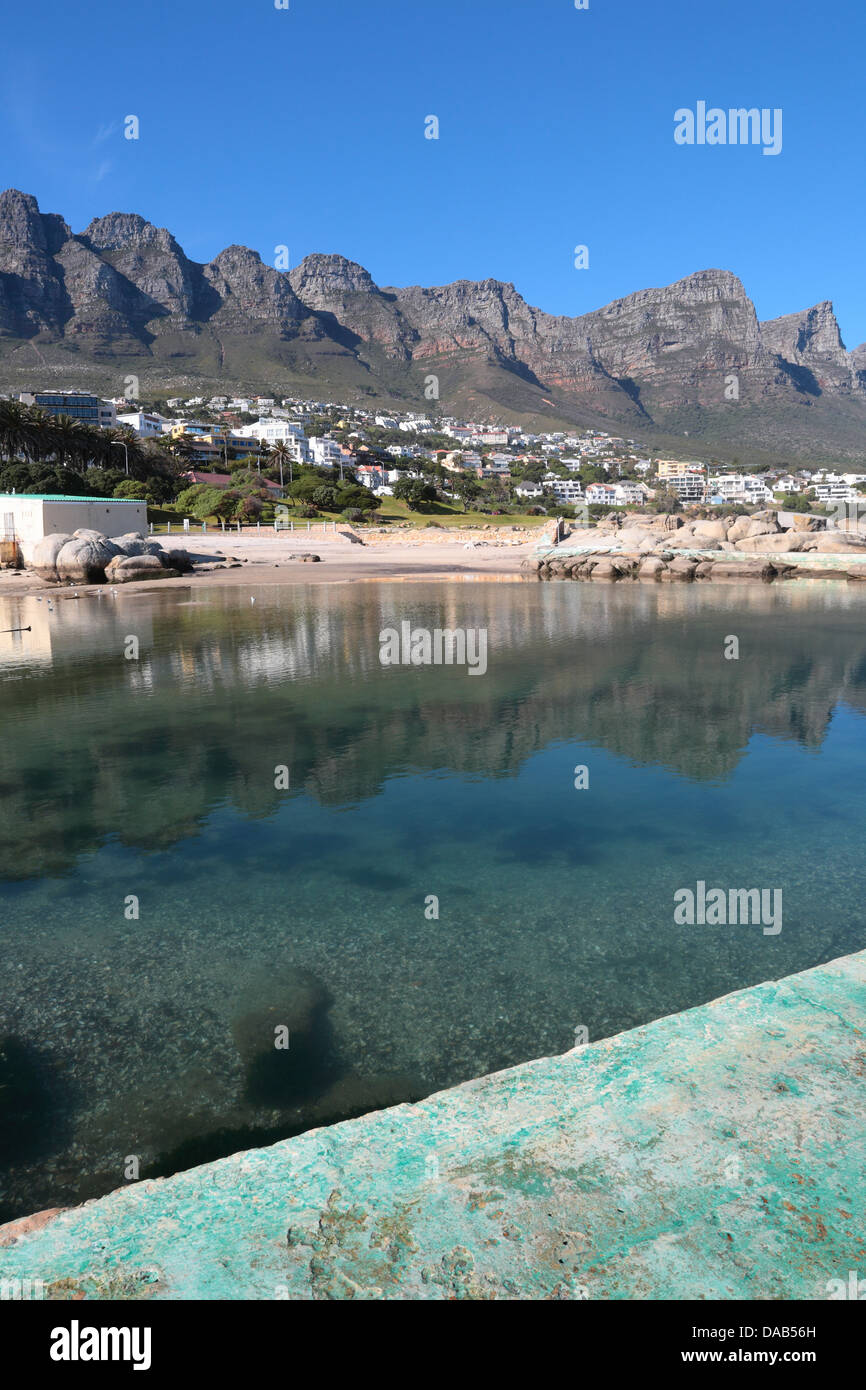 View of the tidal pool and Twelve Apostles (Table Mountain range) from Camps Bay beach, Western Cape Province, South Africa Stock Photo