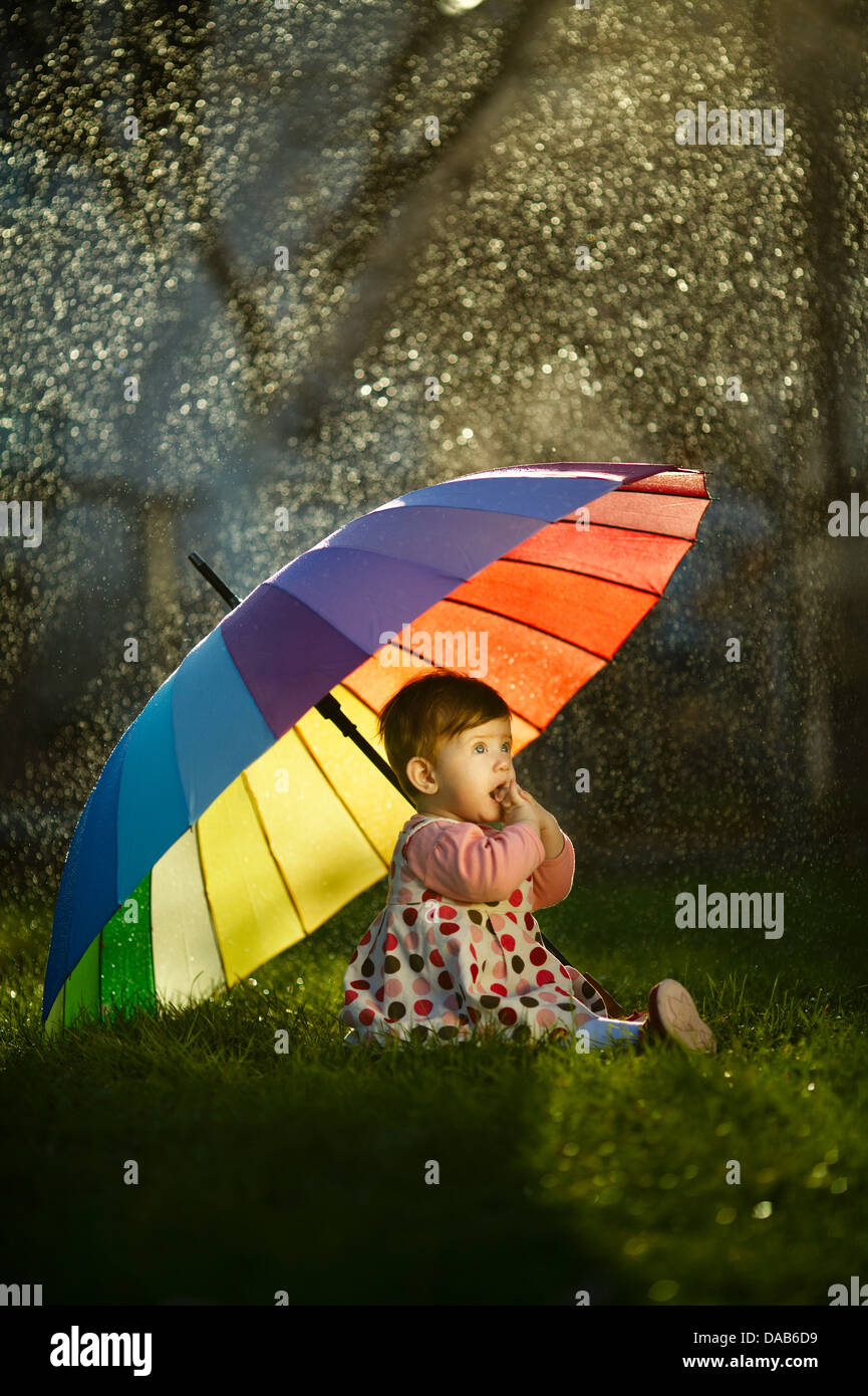 little happy girl with a rainbow umbrella in park Stock Photo - Alamy