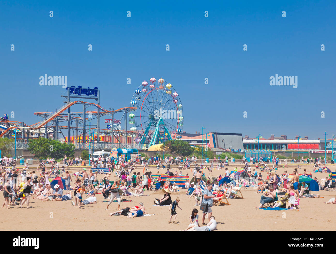 crowded busy Skegness Beach and pleasure beach amusement park Skegness Lincolnshire england UK GB EU Europe Stock Photo