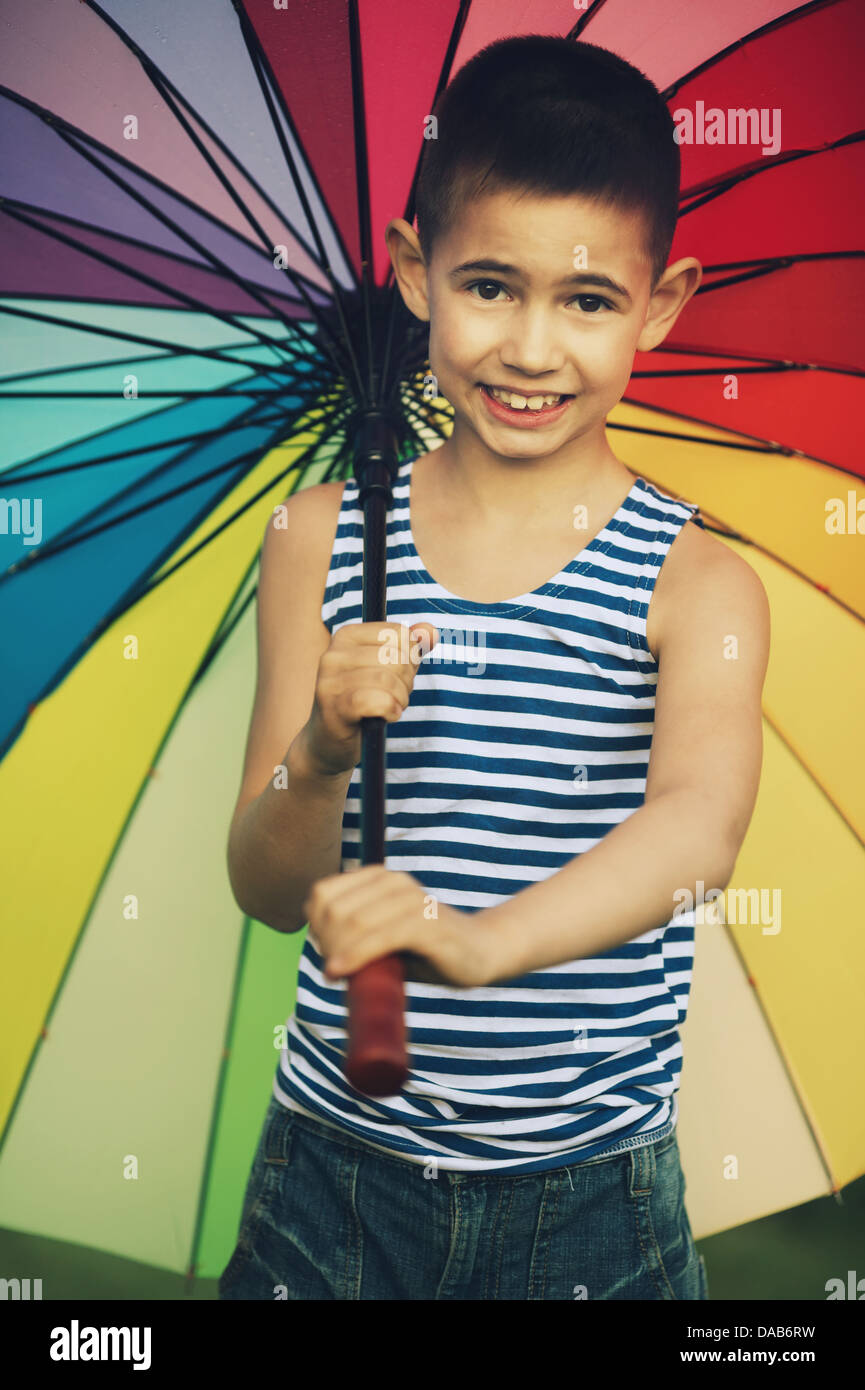 little happy girl with a rainbow umbrella in park Stock Photo - Alamy