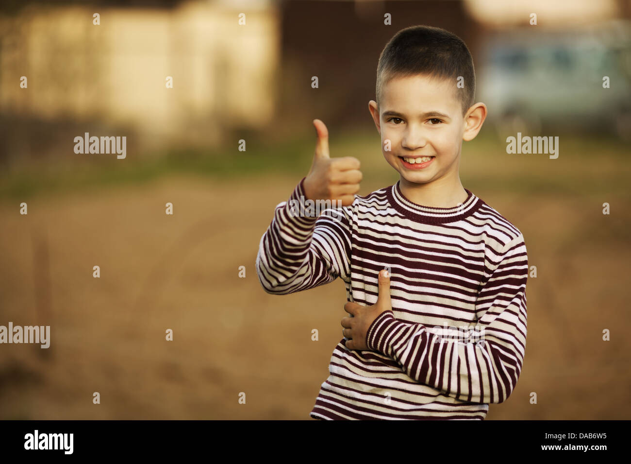 little boy shows thumbs up gesture Stock Photo
