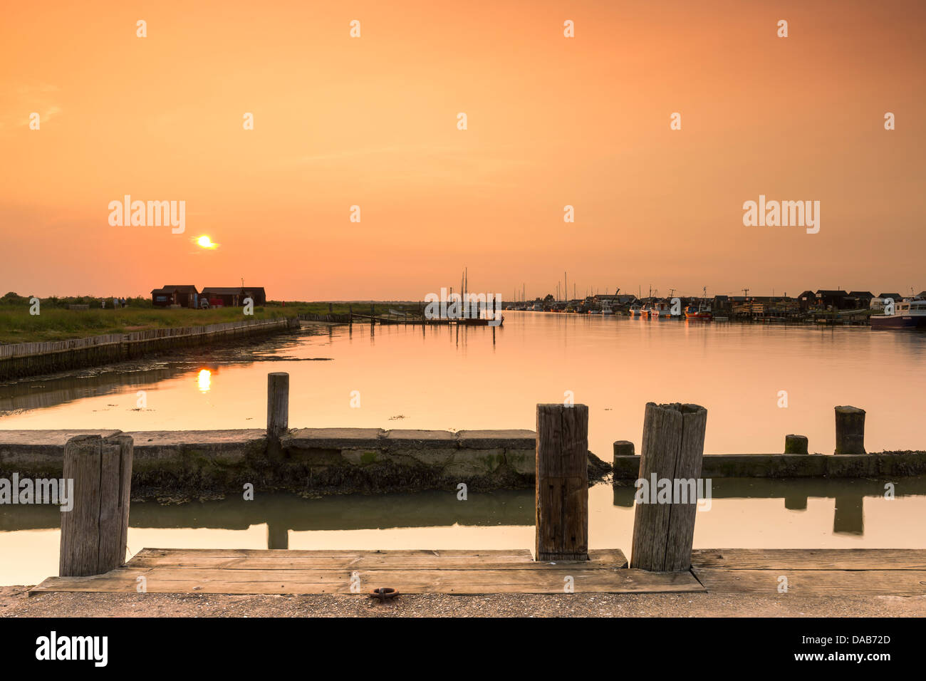 The sun sets over the small harbour at Blackshore, Walberswick in Suffolk. Stock Photo