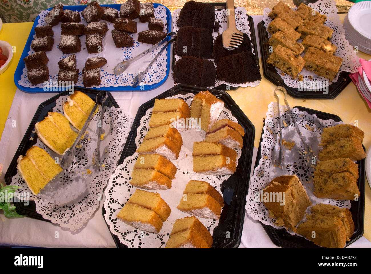 Display of cakes on sale at a village summer fete, East Meon, Hampshire, UK. Stock Photo