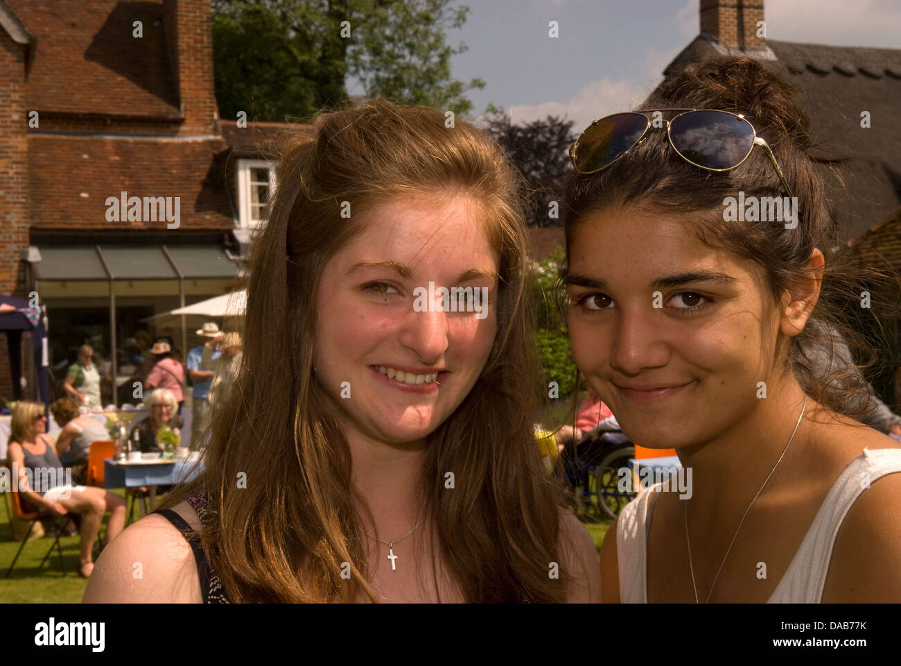 Two 15 year old friends at a village summer fete, East Meon, Hampshire, UK. Stock Photo