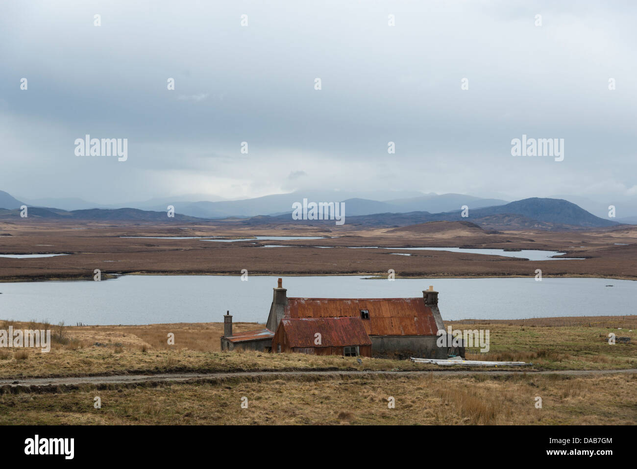 View from Achamore on the A858 on the Isle of Lewis looking across moorland to the hills of Harris shrouded in cloud Stock Photo