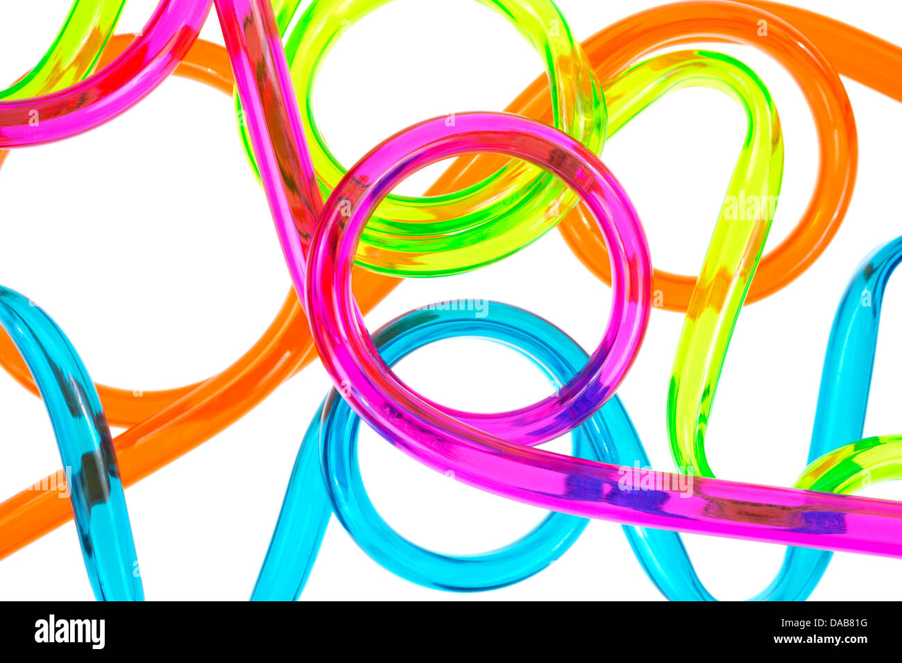 Close view of several plastic tubes that have been bent and looped on a white background. Stock Photo