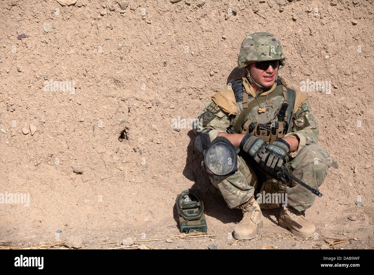 A Georgian soldiers assigned to the 33rd Light Infantry Battalion takes a break from a foot patrol during Operation Northern Lion II July 3, 2013 in Helmand province, Afghanistan. Stock Photo