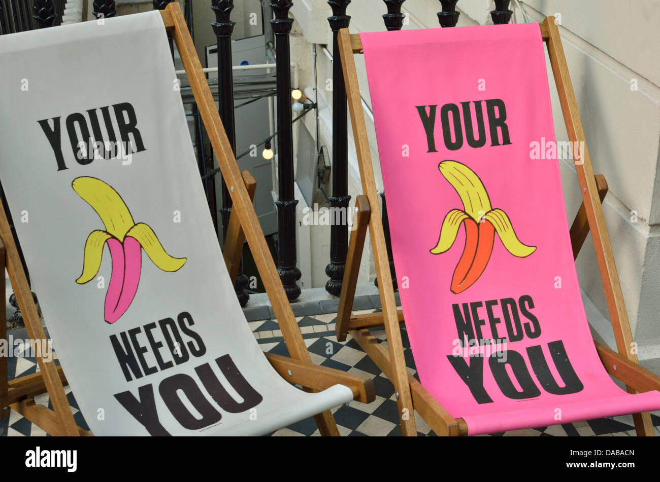 'Your Banana Needs You' street art on deck chairs by Suby, London, UK Stock Photo