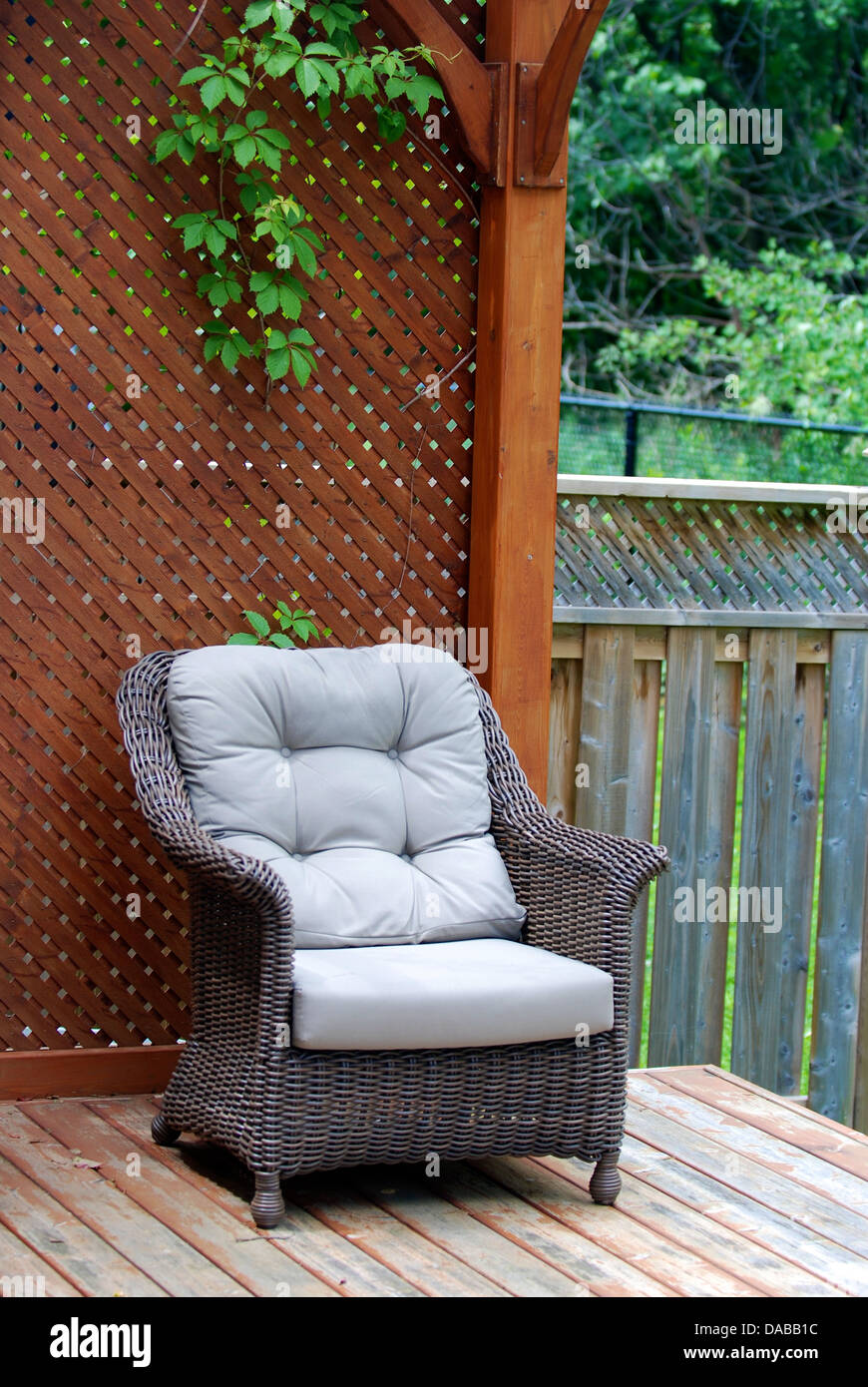 Wicker chair on a deck Stock Photo - Alamy