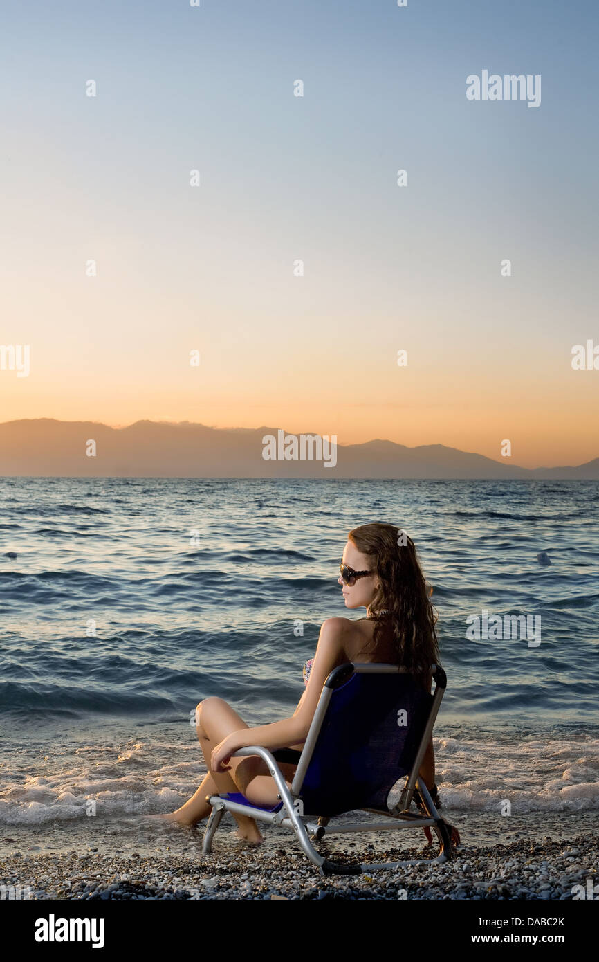 Woman chair sitting on beach watching hi-res stock photography and ...