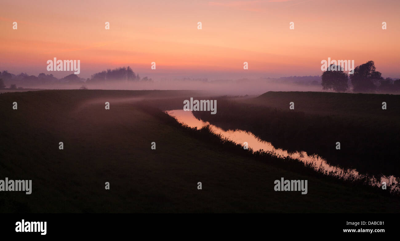 Sunset over the misty marshes of Kent near Bodiam UK Stock Photo
