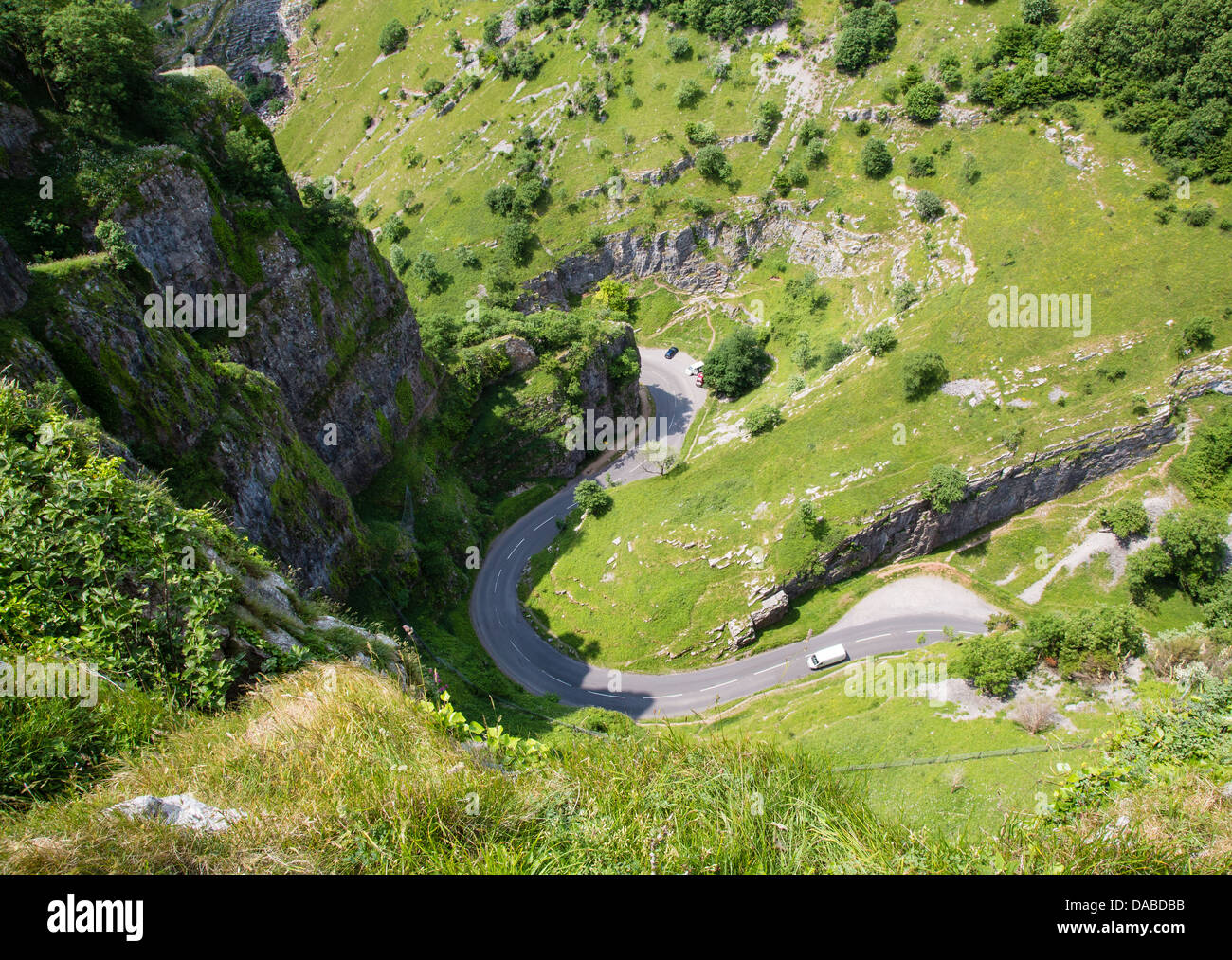 Looking straight down the cliffs of the Cheddar Gorge at the steep winding road in the gorge floor Somerset UK Stock Photo