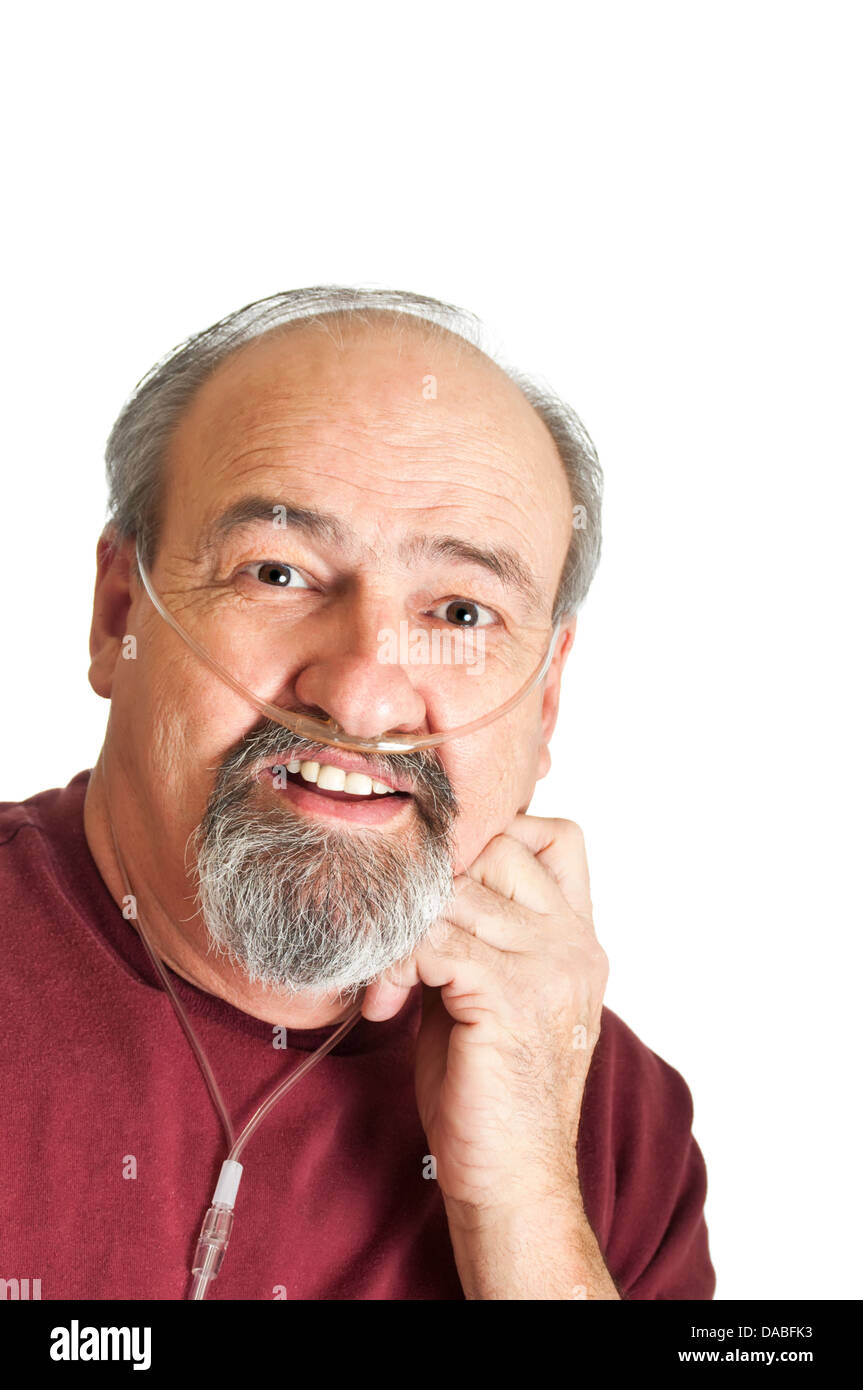 Mature adult man with a breathing disability wearing a cannula for supplemental Oxygen to his lungs. Stock Photo