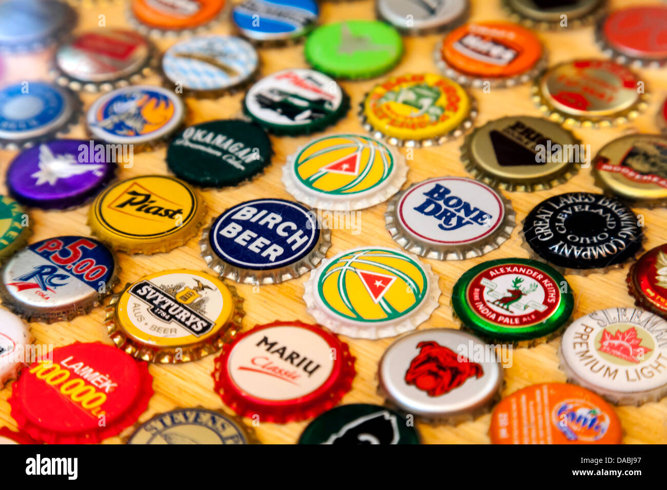 Colorful beer and beverage bottle caps laminated into a countertop. Stock Photo