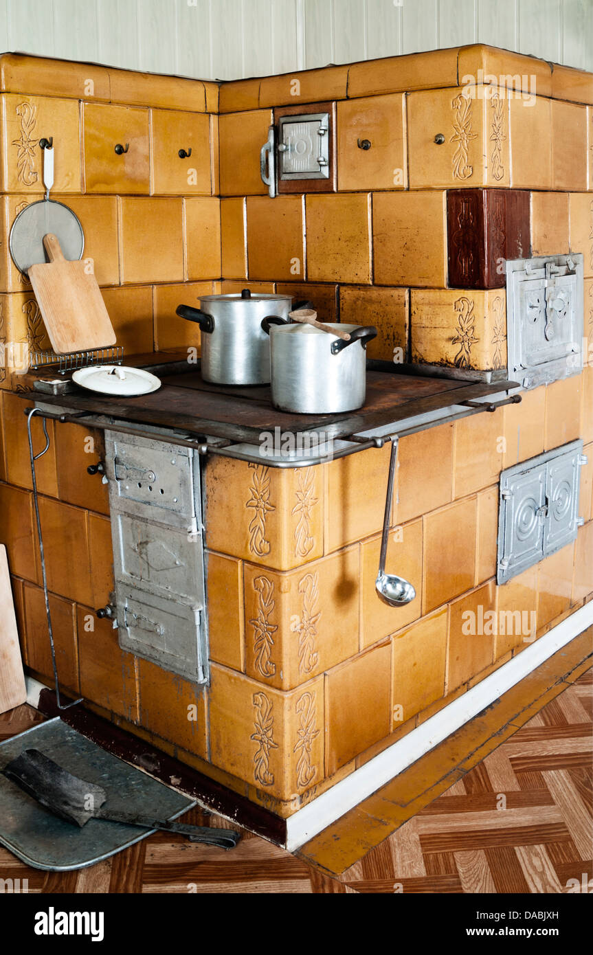Vintage kitchen stove with aluminum pots and other utensils Stock Photo