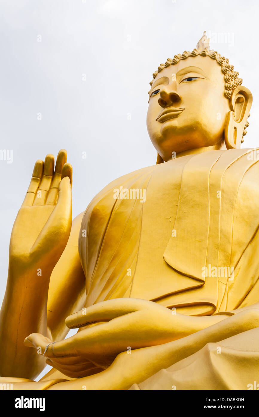 Big Buddha image in action sit cross-legged one hand up Stock Photo