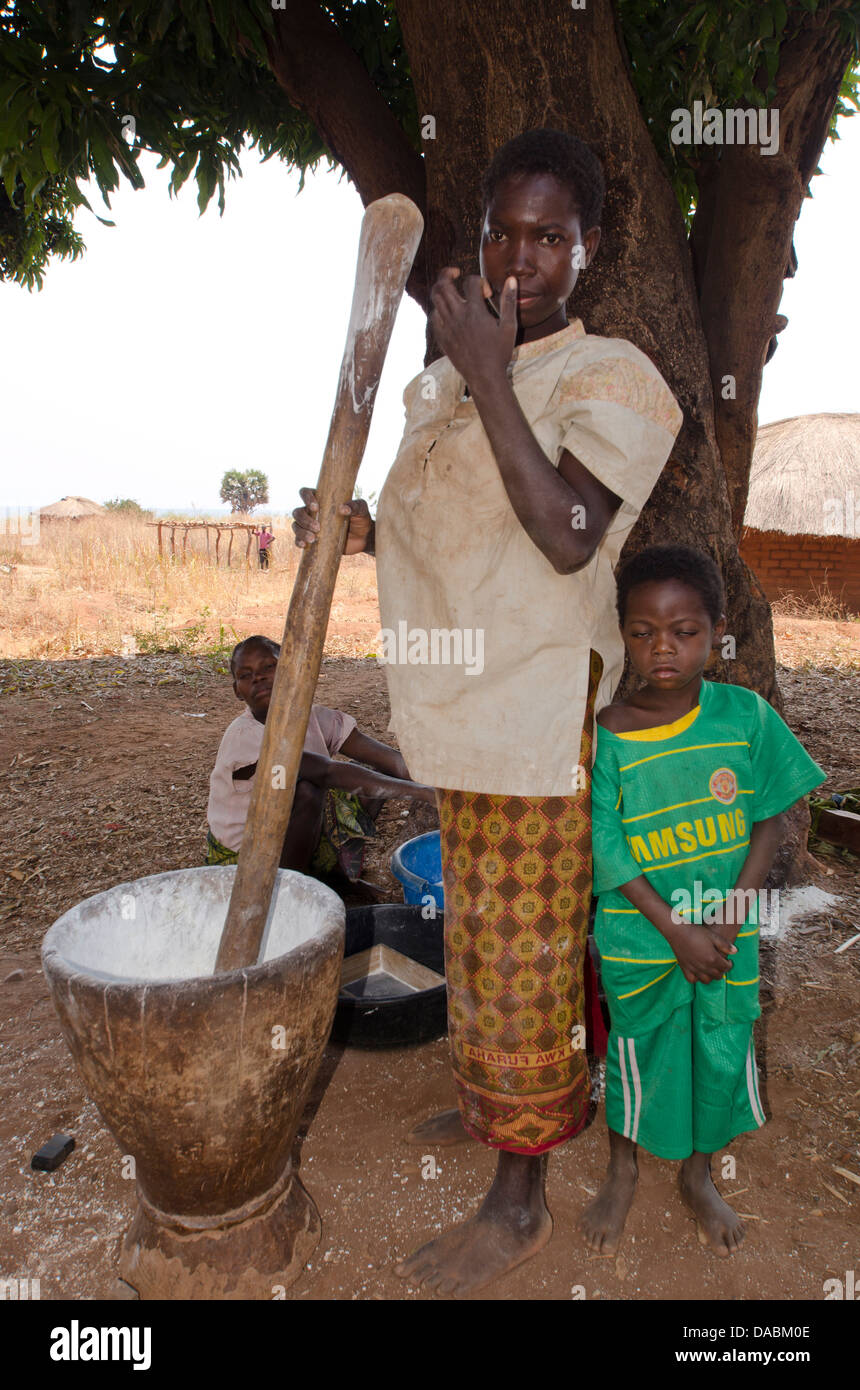 Lady pounding cassava, Talpia, Zambia, Africa Stock Photo