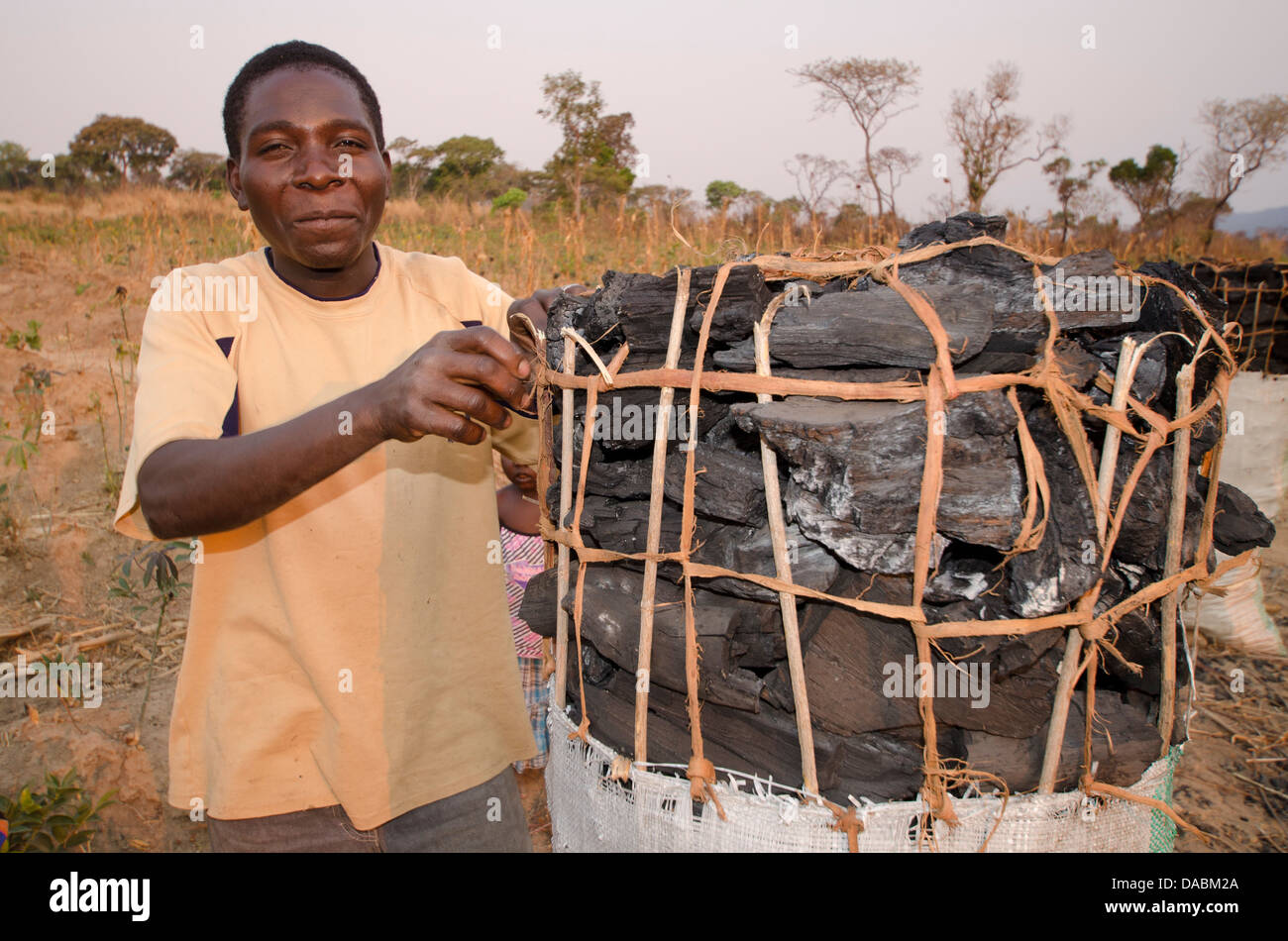 Charcoal maker selling charcoal on the side of the road, Zambia, Africa Stock Photo