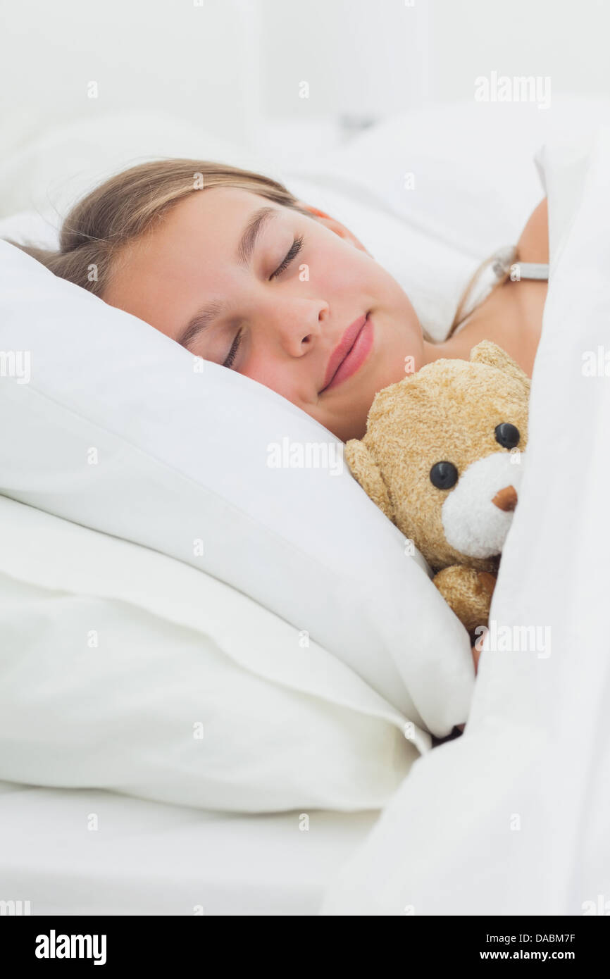 Cute girl sleeping with her teddy bear Stock Photo - Alamy