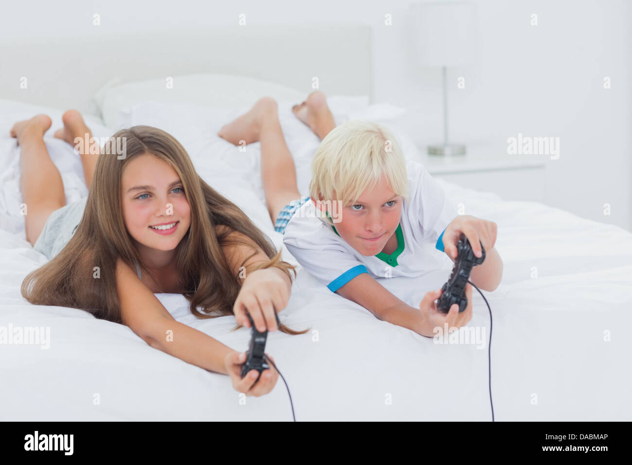 Siblings playing video games Stock Photo