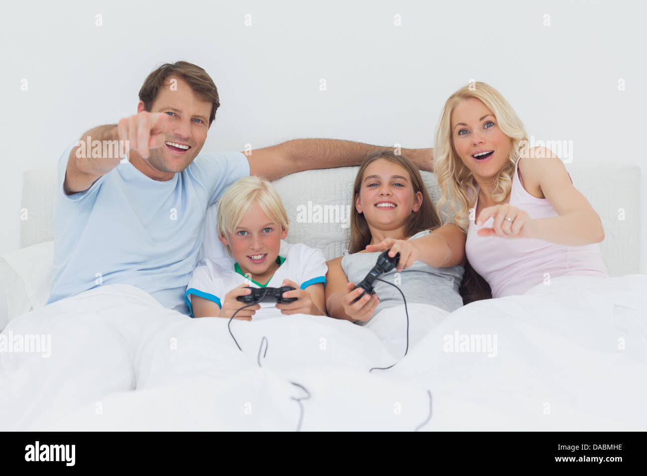 Children playing video games in bed Stock Photo Alamy