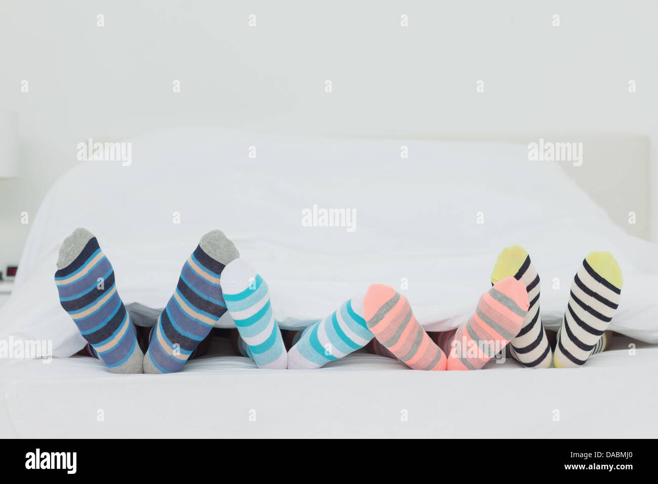 Familys feet in stripey socks Stock Photo