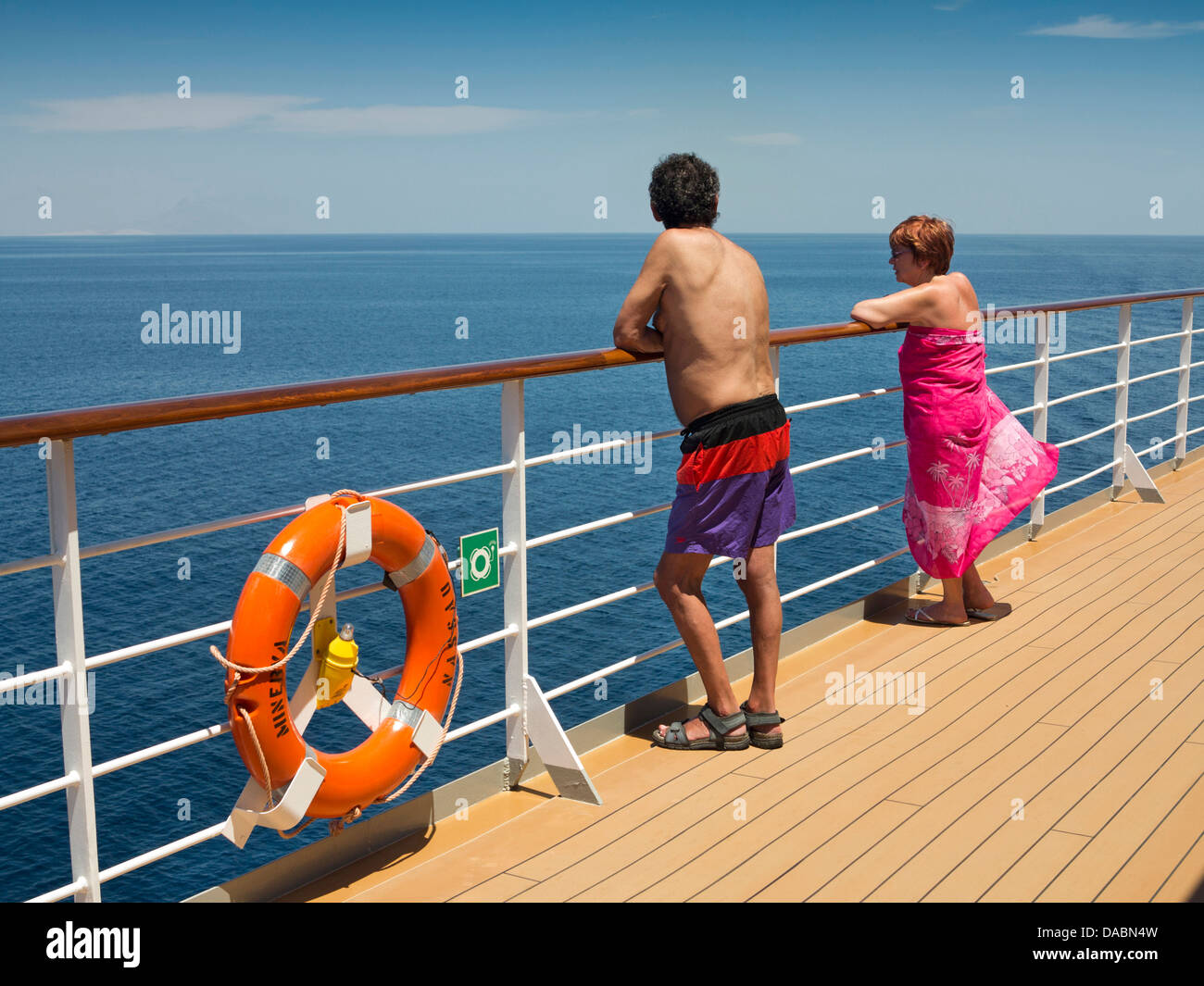 Oman, Dhofar, Salalah, MV Minerva passengers looking out to Arabian Sea over deck rail Stock Photo