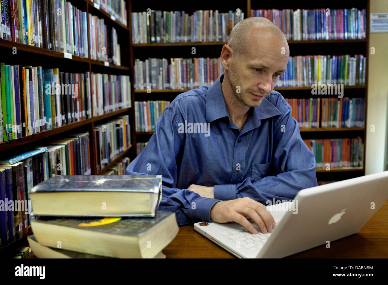 Cape Town South Africa Michael works on laptop on desk in library He is