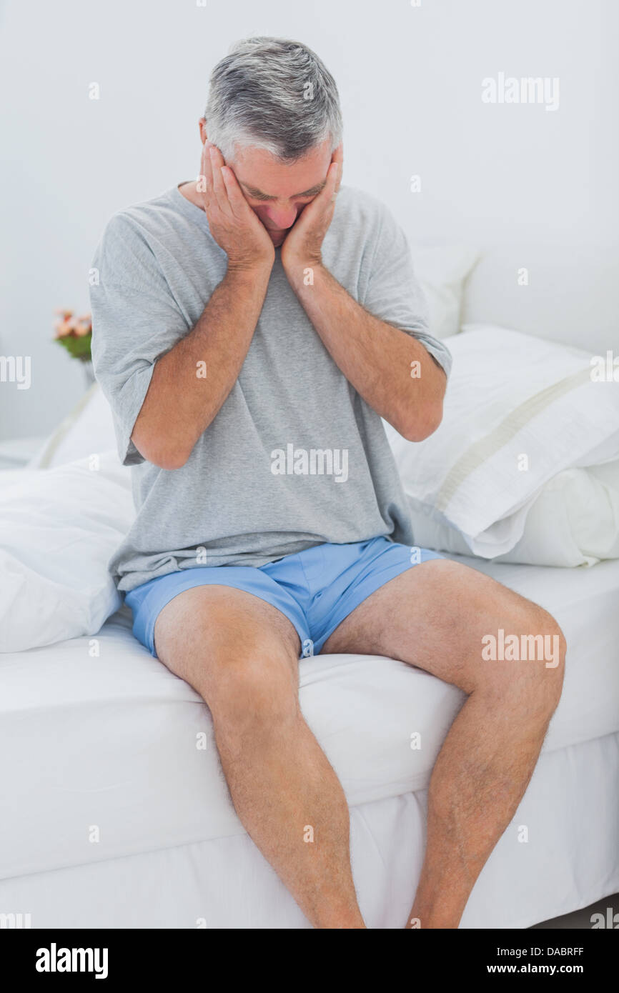 Man getting off the bed Stock Photo Alamy