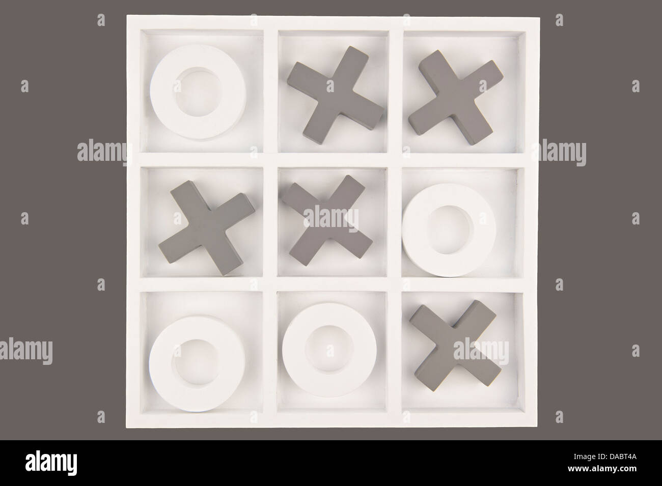 Wooden noughts and crosses game board in gray and white colors isolated in gray background Stock Photo