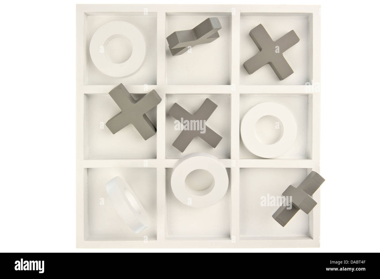 Wooden noughts and crosses game board in gray and white colors and mixed stones isolated in white background Stock Photo