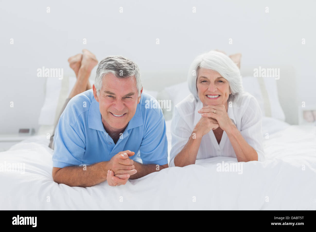 Couple lying together on bed hi-res stock photography and images - Alamy