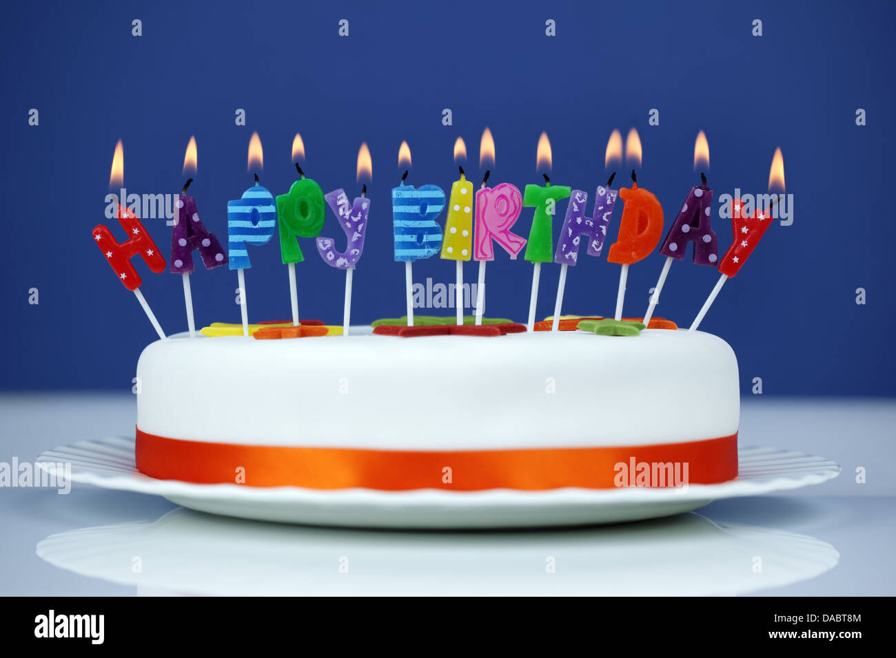 Happy birthday candles on a cake Stock Photo