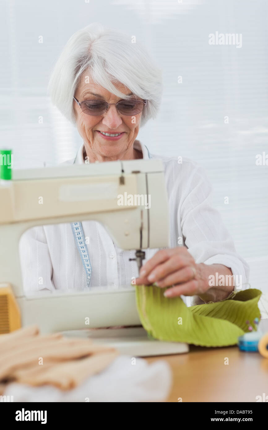Woman using the sewing machine at home Stock Photo Alamy