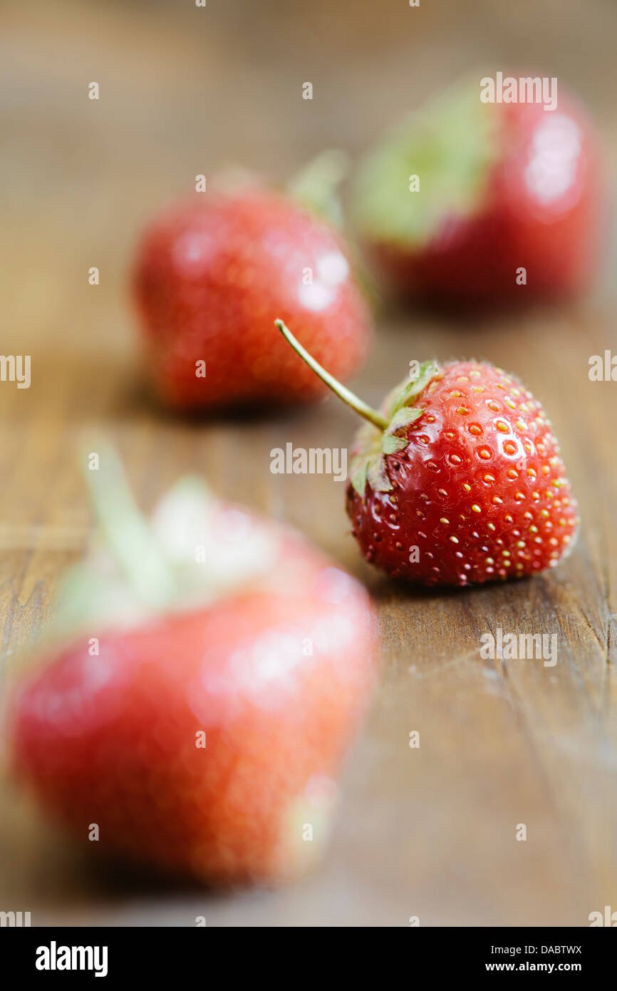 Beautiful red strawberries on the wooden table Stock Photo - Alamy