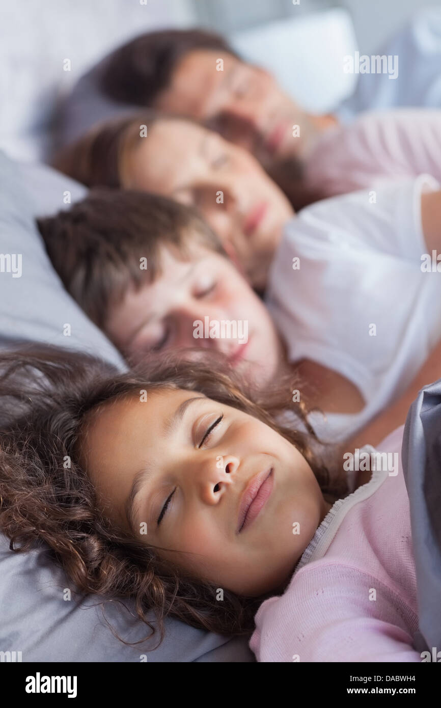 Family sleeping in bed Stock Photo Alamy