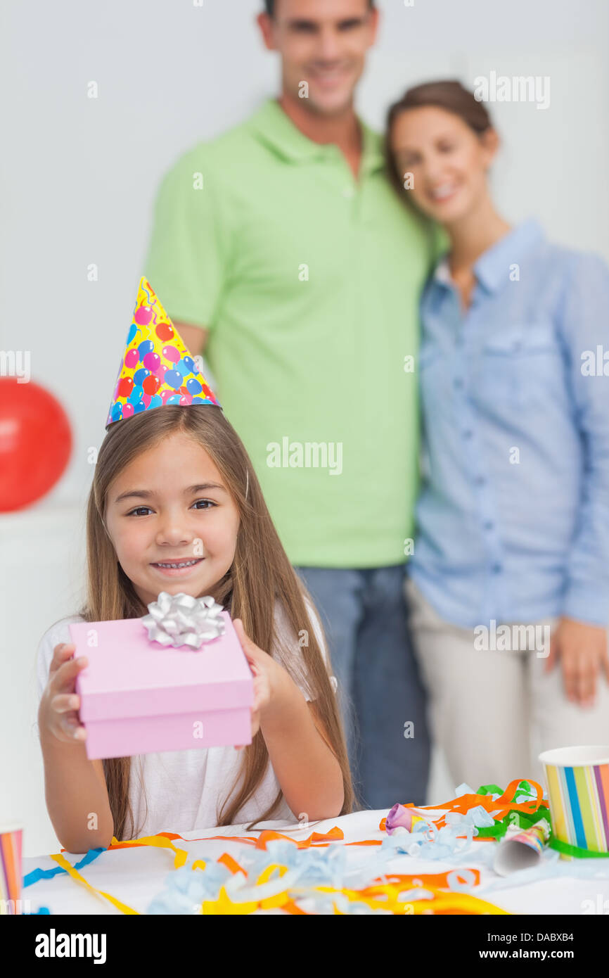 Little girl holding a birthday gift Stock Photo
