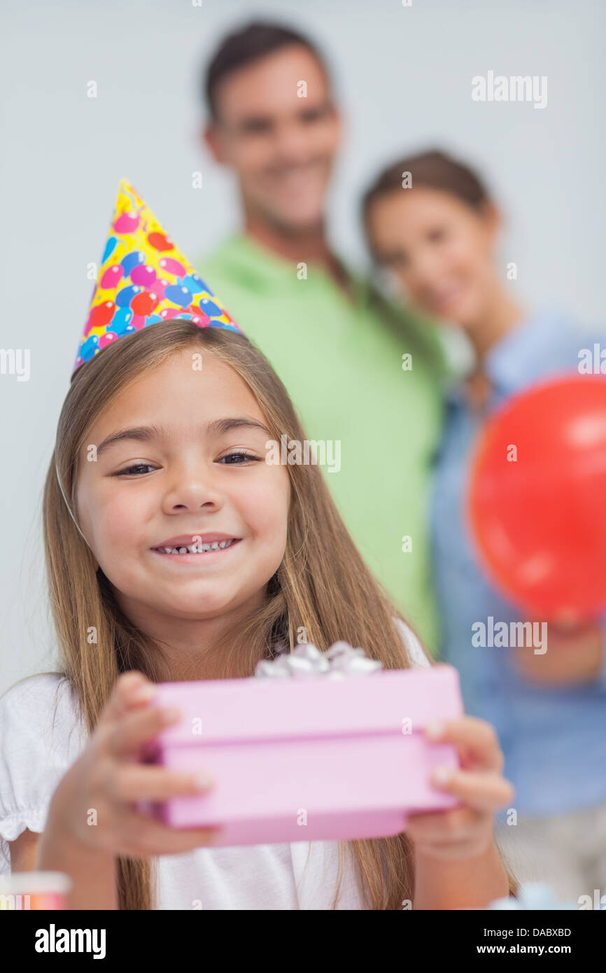 Little girl holding a birthday present Stock Photo - Alamy