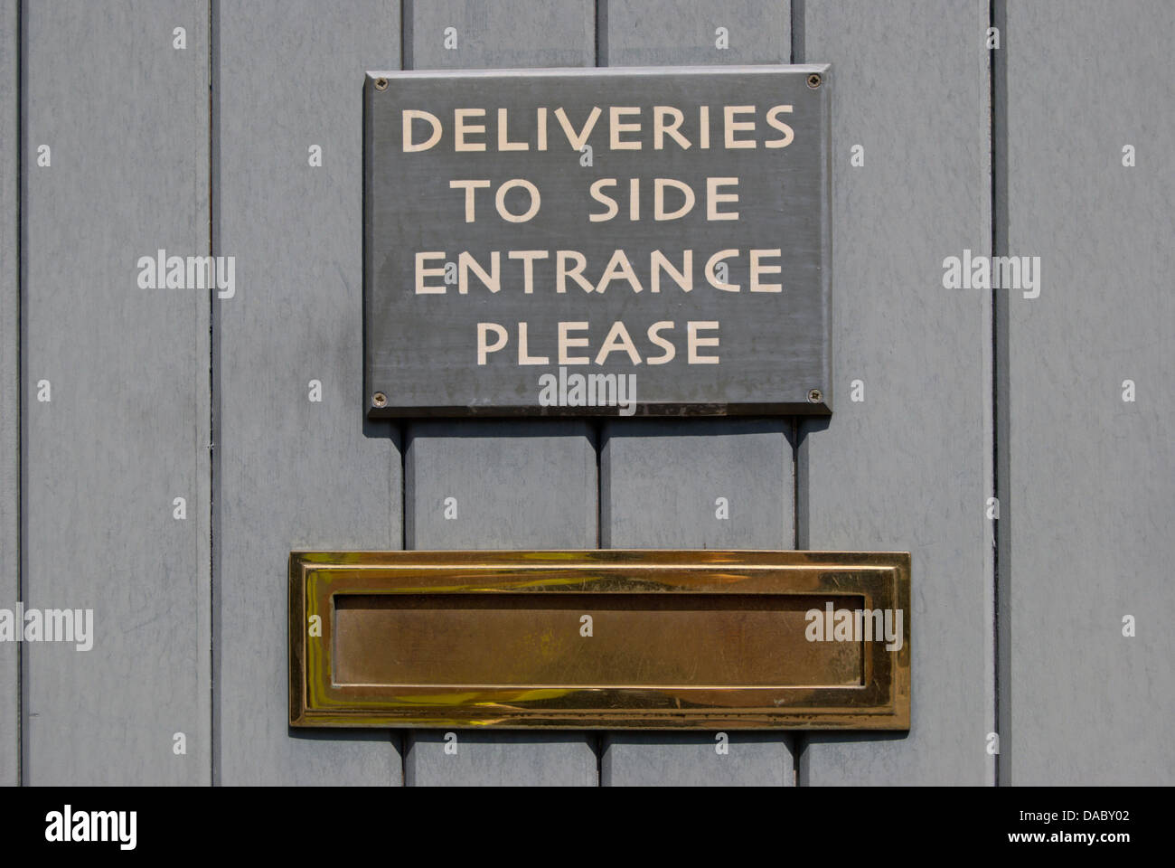 Door Notice Above Letter Box Stating Deliveries To Side Entrance