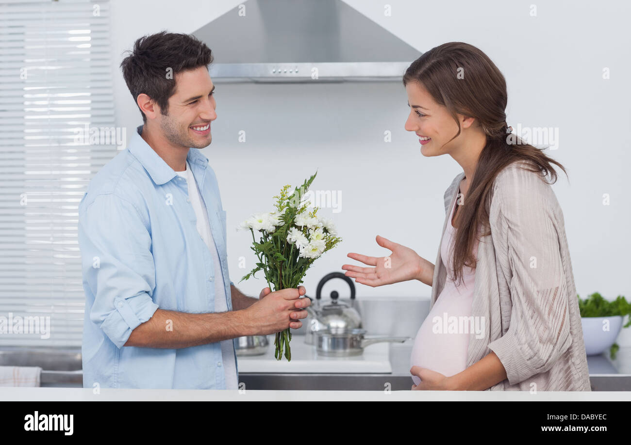 Man giving flowers to his pregnant partner Stock Photo Alamy