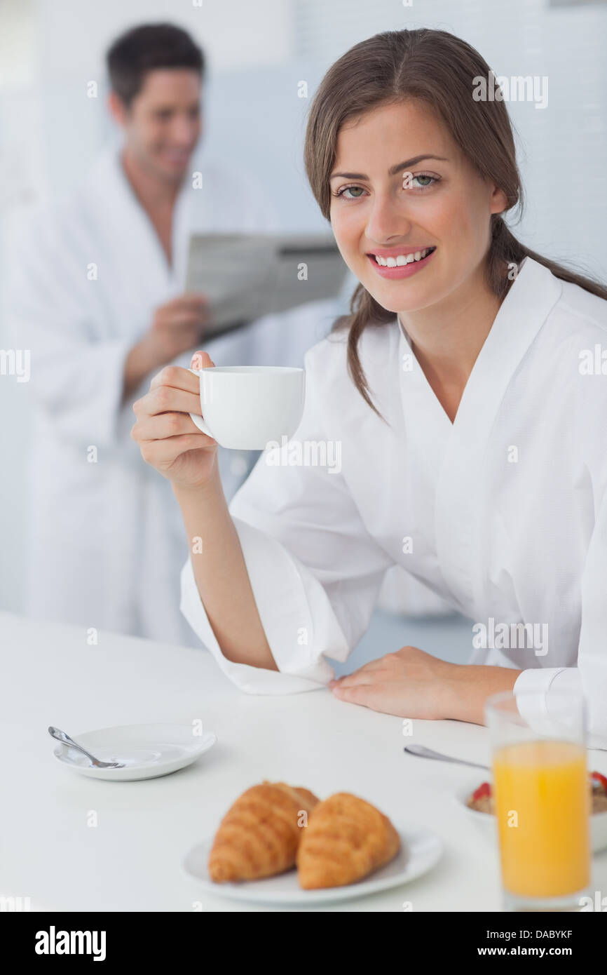 Woman wearing a dressing gown having breakfast Stock Photo