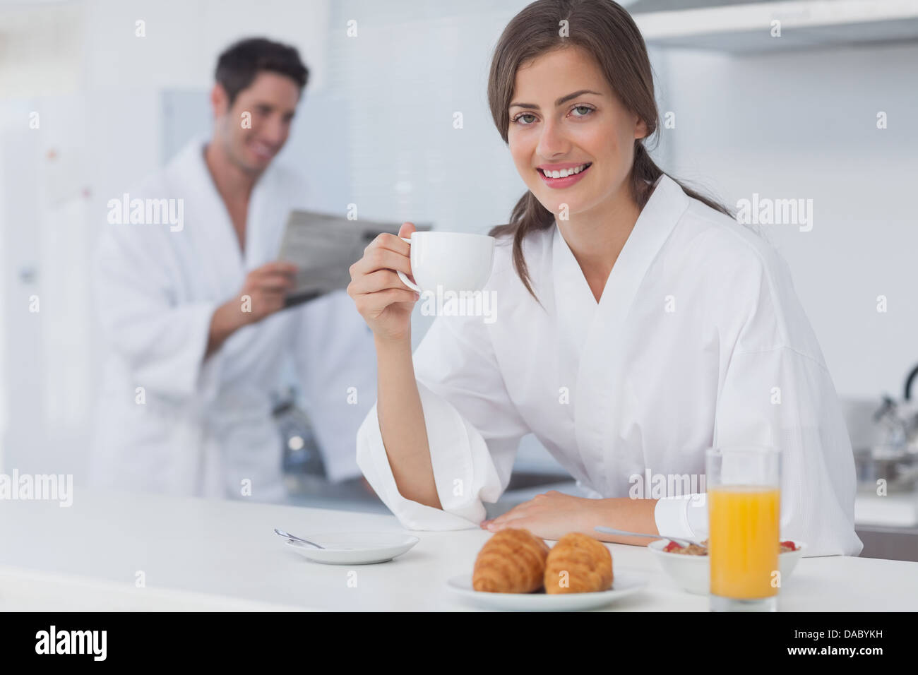 Woman with a dressing gown having breakfast Stock Photo