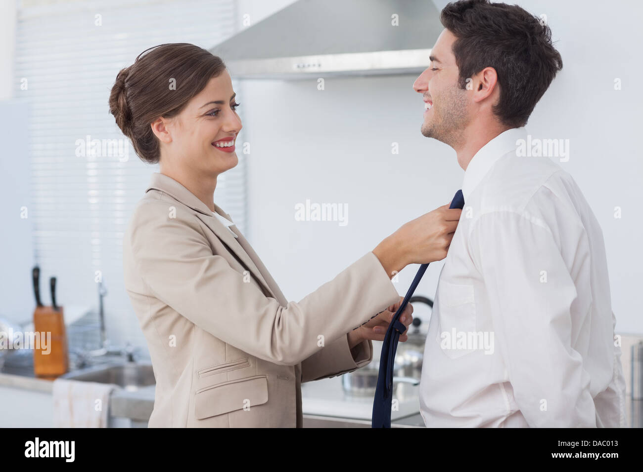 Woman helping her husband to tie his tie Stock Photo Alamy