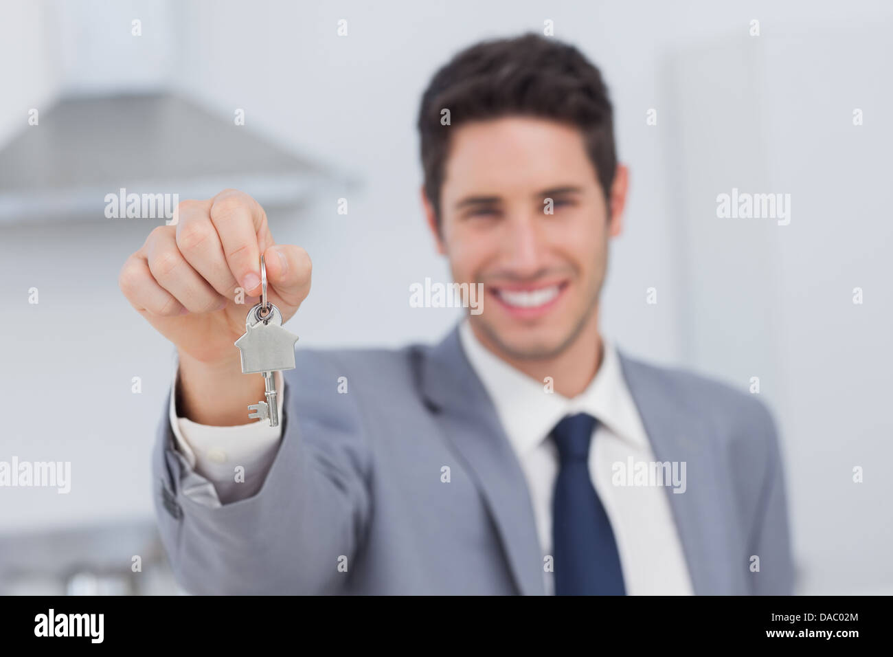 Real estate agent presenting house key Stock Photo Alamy
