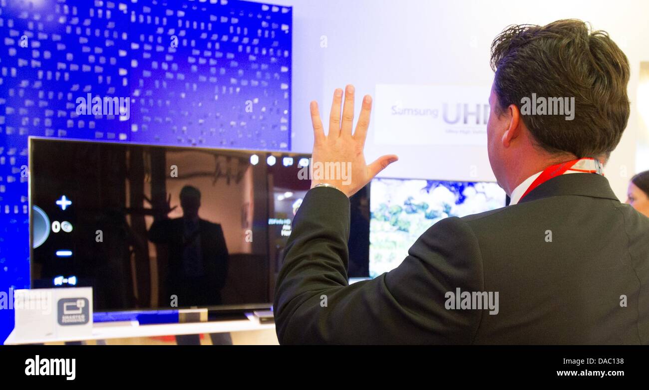 Handheld Testing Tv A man tests the new 'Samsung UHD TV' at fair 'IFA Innovation Media ...
