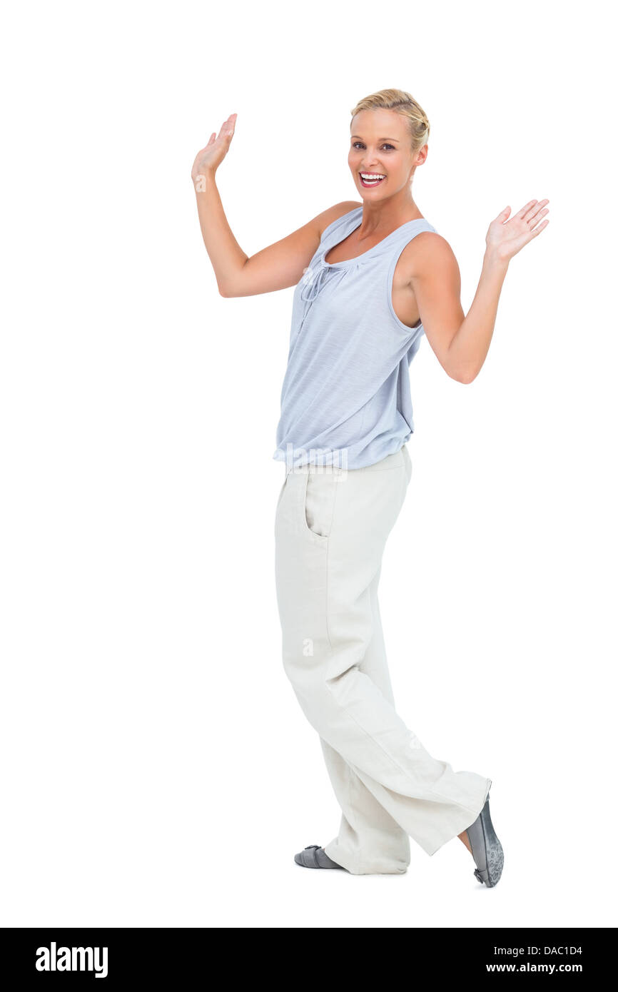 Woman looking at camera with hands raised Stock Photo